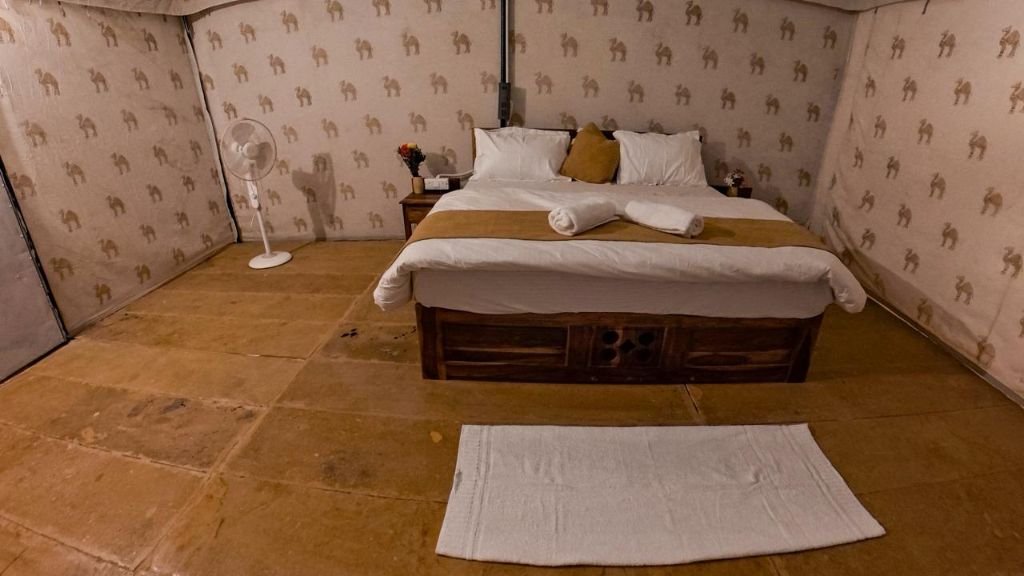 Comfortable bed inside a luxury desert tent