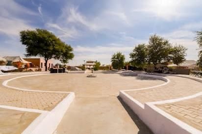 Circular plaza pathway at desert camp during daytime